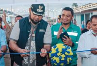 Bupati Halmahera Selatan, Hasan Ali Bassam Kasuba, memotong pita tanda diresmikannya Kawasan Ekonomi Desa Kawasi. (Dok. Harita Nickel)