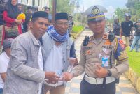 Kanit Rekiden Ipda Rucky Richardo bersama persinil Satlantas Polres Halut bagikan air mineral ke masa aksi.(istimewa)